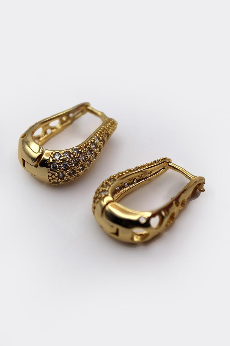 Gold earrings with intricate designs on a white background