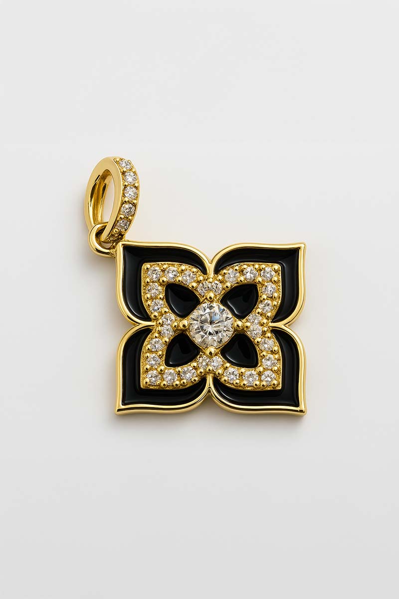 A black enamel floral motif pendant with a gold outline and a central crystal, encrusted with white stones.