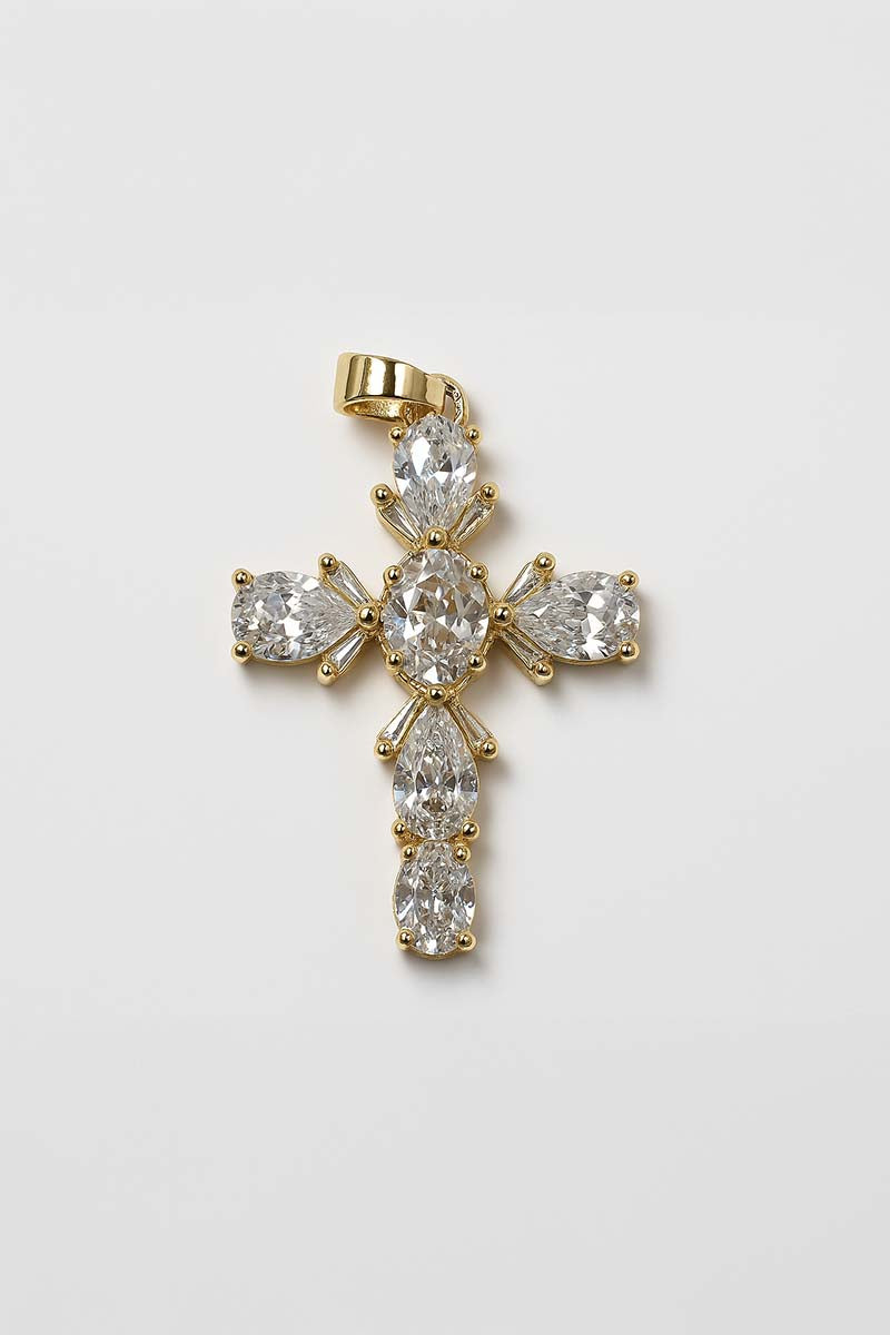 A gold-plated cross pendant adorned with multi-cut cubic zirconia stones.